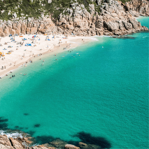 Wander the white sands of Porthcurno Beach – a short four-minute drive away 