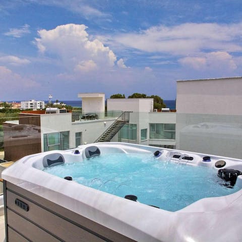 Enjoy rooftop views from your hot tub with the Mediterranean  in the distance