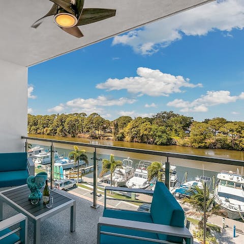Sip a glass of wine on the balcony overlooking the river
