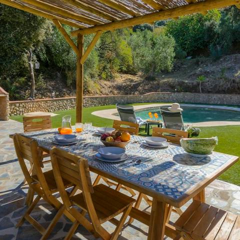 Gather together for an alfresco barbecue feast beneath the pergola