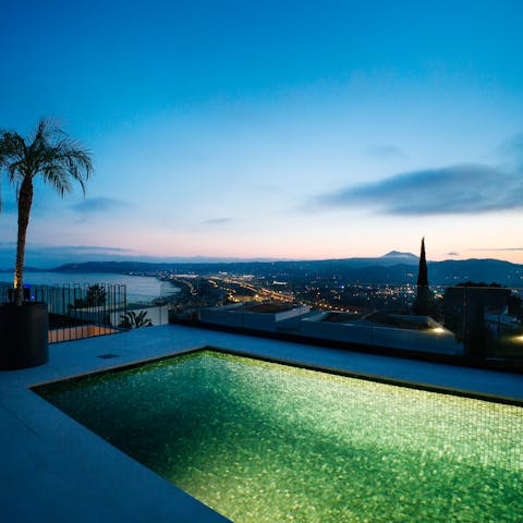 Enjoy an evening swim in the saltwater pool as the town lights twinkle before you