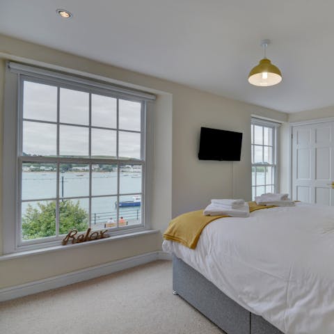 Wake up to the stunning view of boats bobbing in the harbour