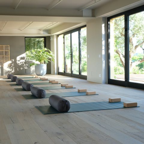 Greet the day with early morning yoga sessions overlooking the pool