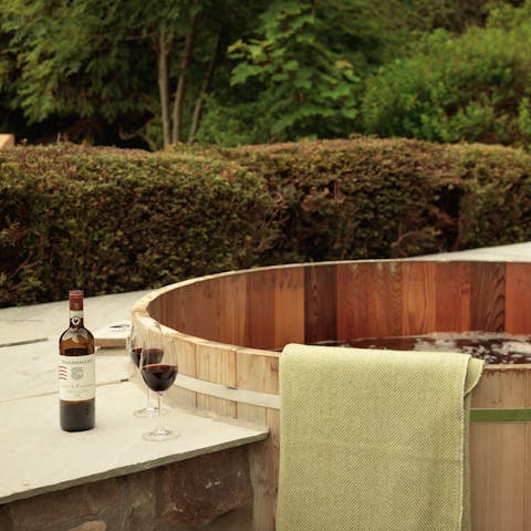 Relax in the cedar hot tub after a busy day exploring the local trails