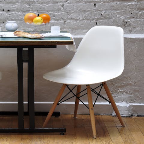 Sit down on a contemporary Eames-style chair for your morning coffee 