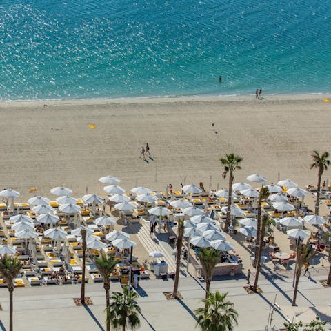 Stretch out and soak up the Dubai sun from your resort's private beach