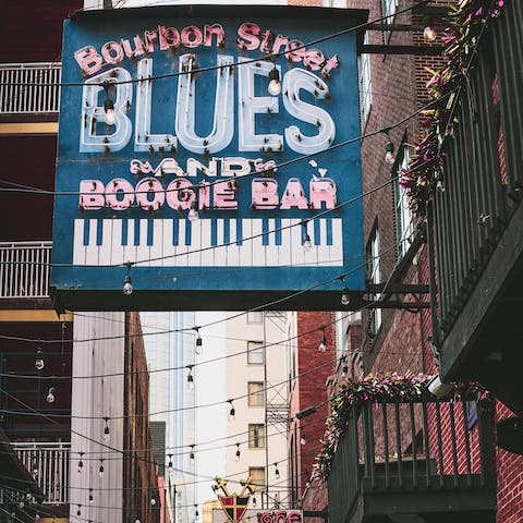 Follow the jazz beats down to Bourbon Street, just a ten-minute streetcar ride away