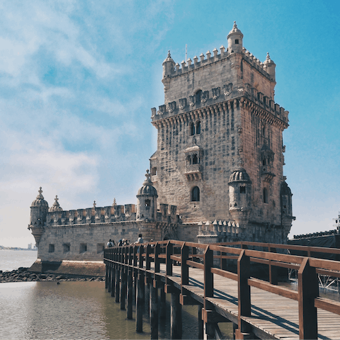 Visit medieval Belém Tower, a fortified landmark offering estuary views