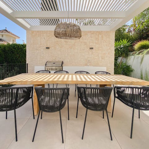 Fire up the barbecue for a grilled feast under the pergola