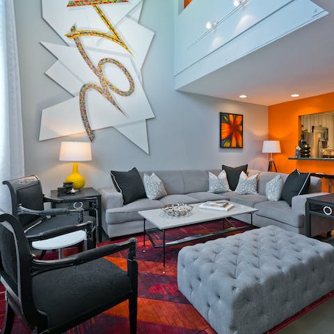 Hang out under the high ceilings and unique artwork of the living room