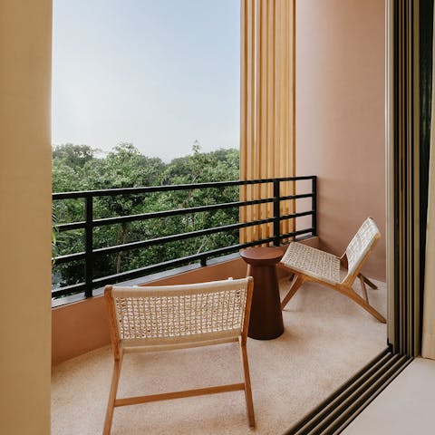 Admire the lush views of the treetops from the private balcony