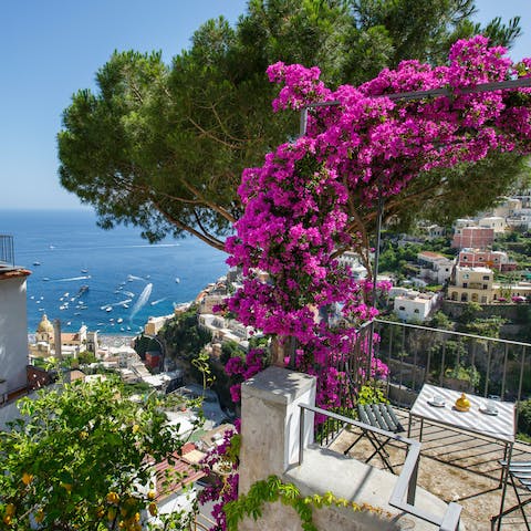 Enjoy a spot of breakfast at the bistro set surrounded by bright sprays of bougainvillea