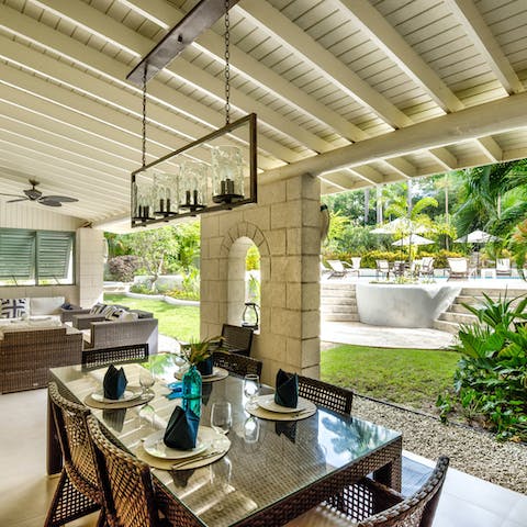 Fire up the grill for a grilled feast under the shaded pergola