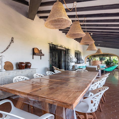 Dine in the shade of the rustic terrace at the banquet-sized table