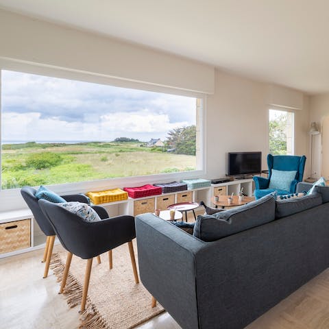 Relax in front of the sparkling seascape from the comfy lounge set-up