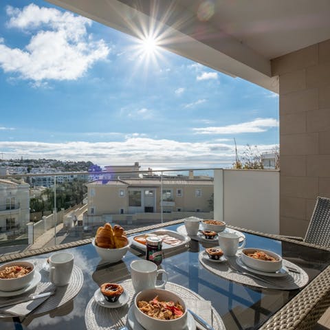 Steal a glimpse of the sea over breakfast on the private balcony