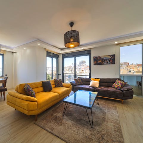 Kick back in the stylish living area while admiring city views from the floor-to-ceiling windows