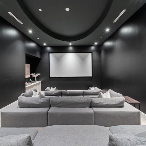 Gather for cosy movie nights in the home theatre 