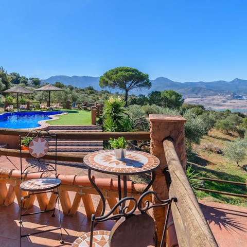 Enjoy dining at this table for two, with breathtaking views beyond the estate