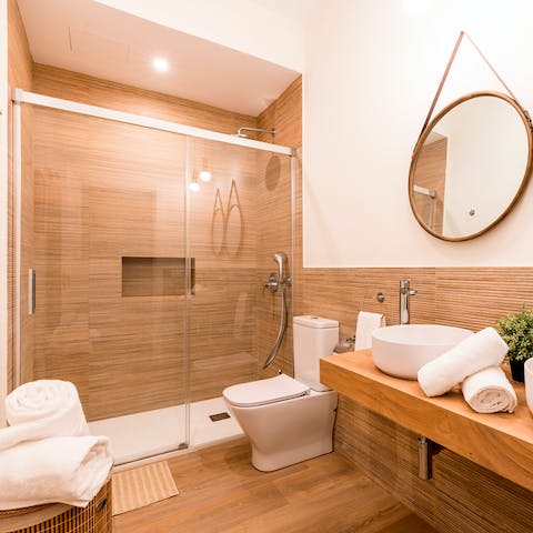 Take a refreshing shower in the wooden bathroom
