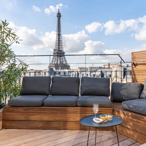 Share an evening glass of wine, overlooked by the iconic Eiffel Tower