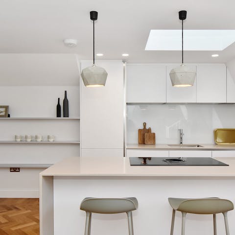 Cook up a feast underneath the skylight in the modern kitchen