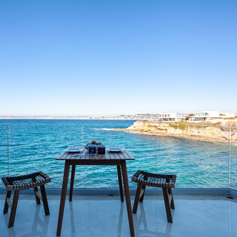 Toast to your getaway on your own private balcony offering incredible views of the sea