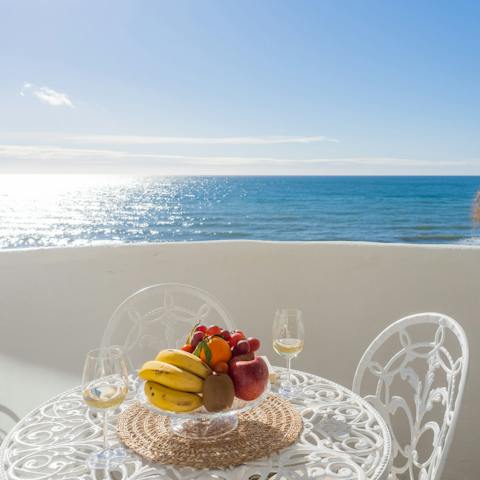 Enjoy the ocean views with a glass of wine on the balcony