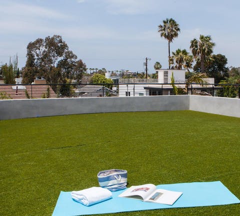 Rise and shine to yoga amid the palm trees on this large roof terrace