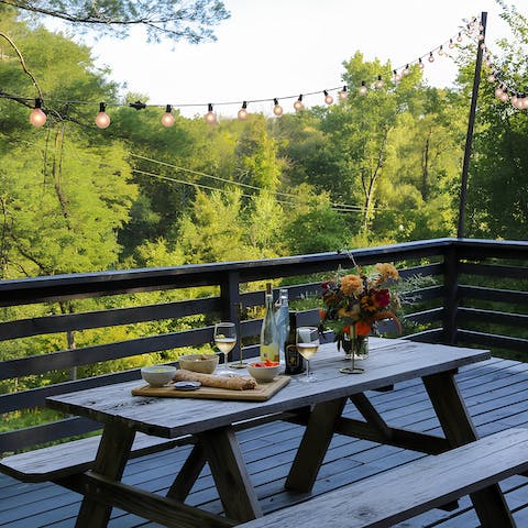 Watch the sunset over the woodland from the deck