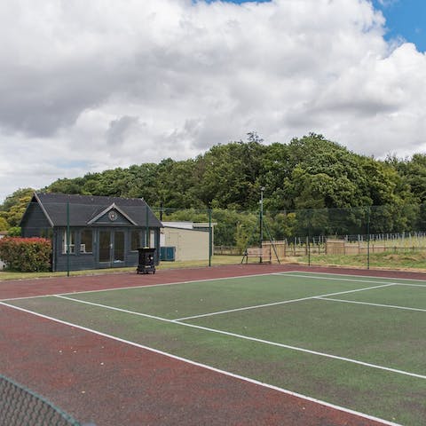 Challenge your partner to a game of tennis on the grounds