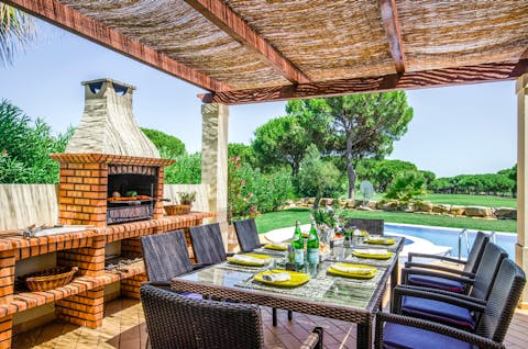 Light the barbecue for an alfresco meal under the shade of the pergola