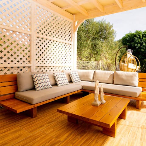 Enjoy a glass of ouzo on the outdoor sofa