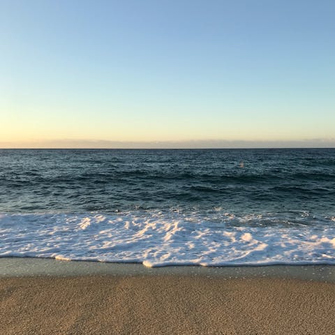 Dip your toes in the water at Praia Grande Beach, just a five-minute walk away