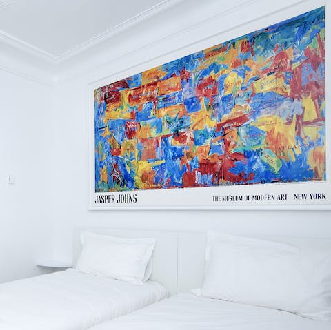 Appreciate the vibrant art work that brings life to the minimal interiors  throughout the home