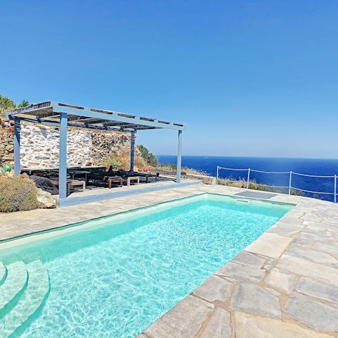 Gaze at the Aegean Sea as you glide across the private pool