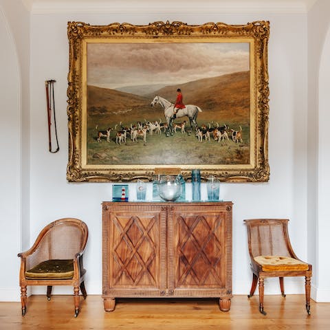 Admire the antique furniture and historic art 