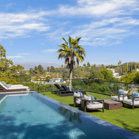 Admire the views from the edge of the pool or the sun lounger