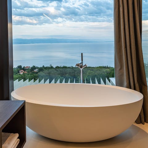 Sink into a hot bath with a picturesque view of the sun shining over the Adriatic Sea