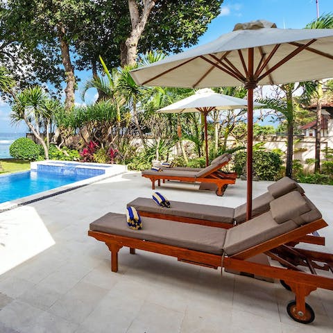 Soak up the tropical setting with sea views from the poolside loungers