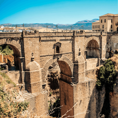 Explore the mountaintop city of Ronda, home to Moorish architecture, striking scenery and a lookout offering views over the deep gorge 