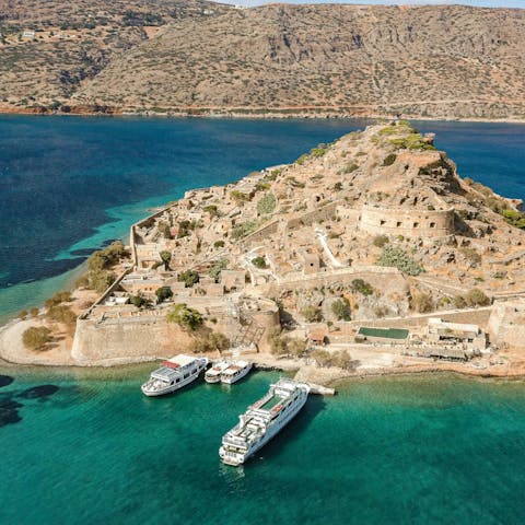 Board a boat in Elounda and travel forty minutes over to the former leper colony on Spinalonga