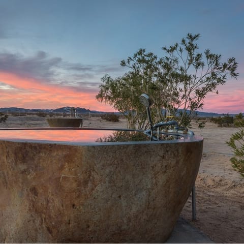 Admire the Mojave desert view from one of the private hot springs soaking tubs