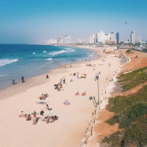 Spend an afternoon relaxing on Aviv Beach, a twelve-minute walk away