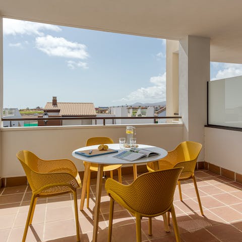 Gather around your private balcony's table for drinks, snacks, and card games while the fiery sun sets