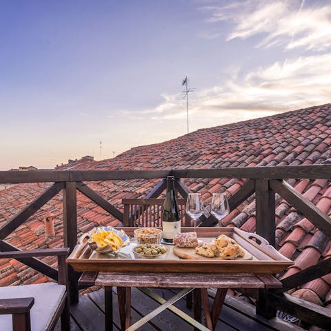 Enjoy an alfresco meal at sunset with rooftop vistas