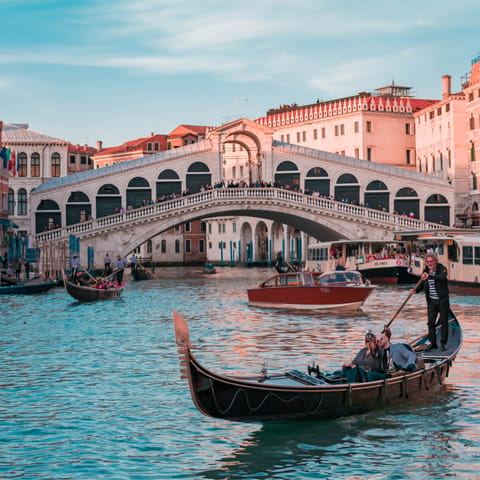 Stroll across Rialto Bridge, a five-minute walk away