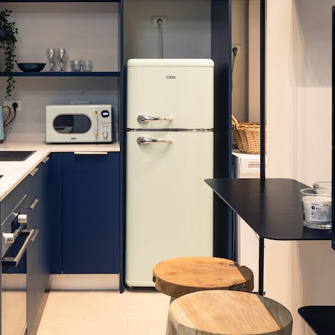 Enjoy cooking with the vintage-style fridge and microwave in the kitchen