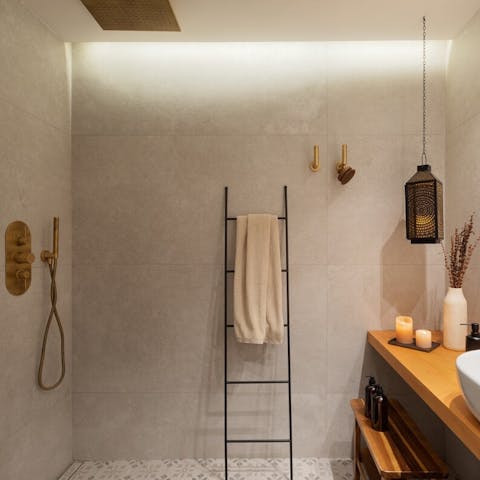 Pamper yourself each morning under the bathroom's luxurious rainfall shower