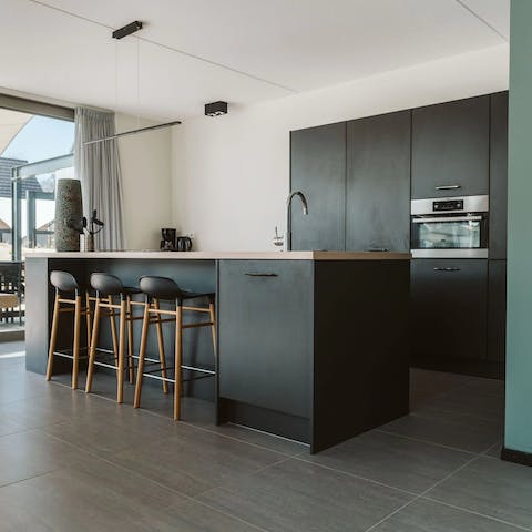 Gather around the sleek kitchen island for drinks, nibbles, and catch ups